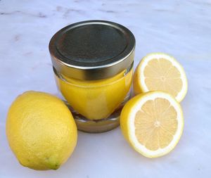 High angle view of lemons in container filled with water on marble