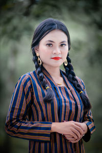 Portrait of young woman standing outdoors