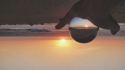 Midsection of man at beach during sunset