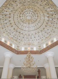 Low angle view of illuminated chandelier hanging in building