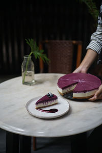 Midsection of woman holding cake in plate