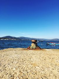 Scenic view of sea against clear blue sky