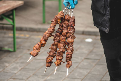 Pork meat skewer, grilled or roasted in a barbecue on an open fire and flames, shashlik or shashlyk