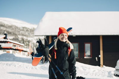 Portrait of young woman standing in snow