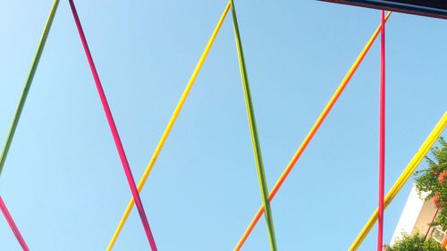 Low angle view of rainbow against clear blue sky