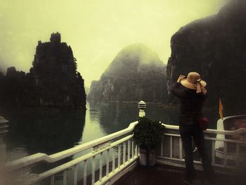 Rear view of woman on pier at halong bay