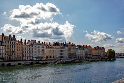 Buildings against cloudy sky