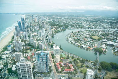 Aerial view of buildings in city against sky