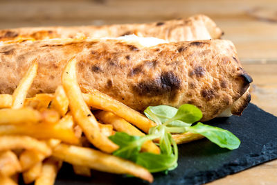 Close-up of french fries with taco