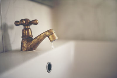 Close-up of faucet in bathroom