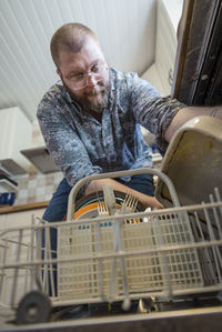 Man putting dishes into dishwasher