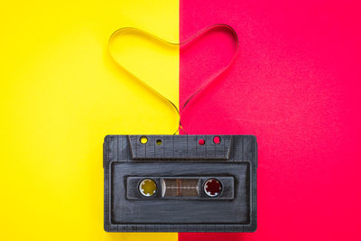 Close-up of audio cassette over colored background
