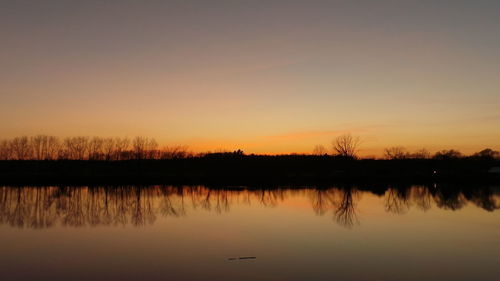 Scenic view of lake at sunset