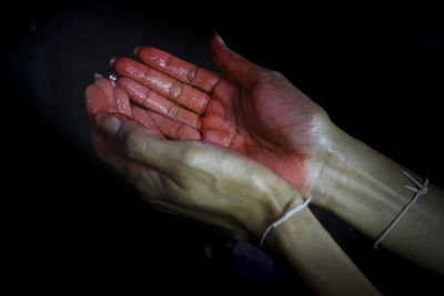 Close-up of hands over black background