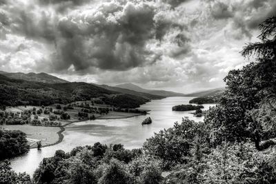 Scenic view of lake against cloudy sky