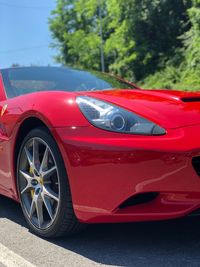 Close-up of red vintage car on road