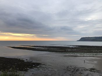 Scenic view of beach against sky during sunset