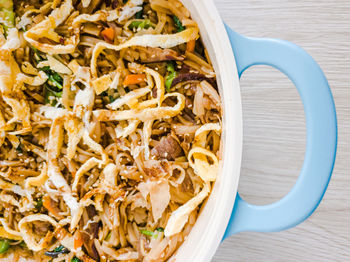 Asian noodle dish in a pot on a table