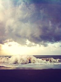 Scenic view of sea against cloudy sky