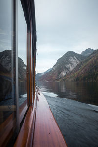 Scenic view of lake by mountains against sky