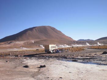 Stream and mountains against clear sky