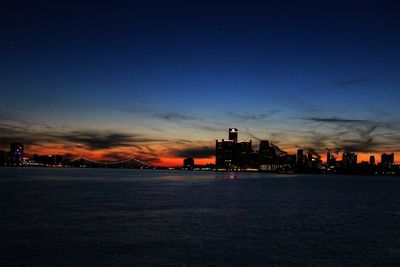Illuminated city against sky at night