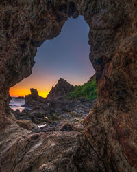 Rock formation against sky during sunset