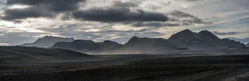 Scenic view of mountains against cloudy sky