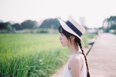 Side view of young woman on field