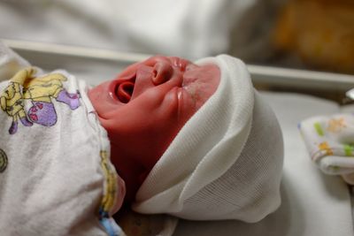 Close-up of cute baby girl screaming while crying in hospital