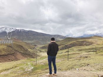 Rear view of man standing on mountain