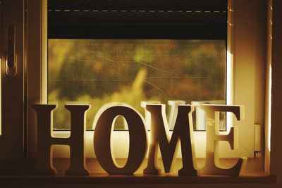 Close-up of home message on window sill at home