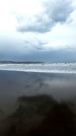 Scenic view of sea against cloudy sky