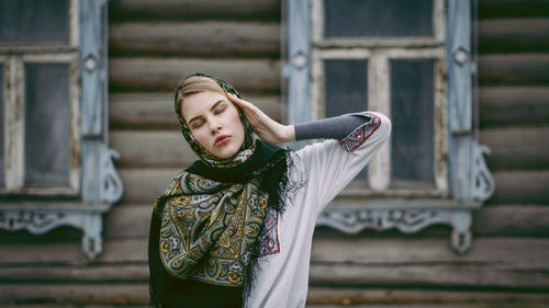 Full length of woman standing against blurred background