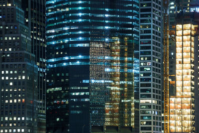 Illuminated modern buildings in city at night