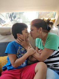 Mother and daughter sitting on floor