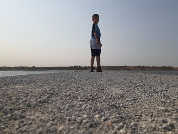 Full length of man standing on land against sky