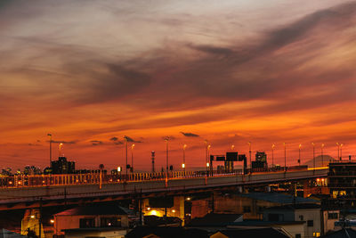 Illuminated bridge against sky during sunset