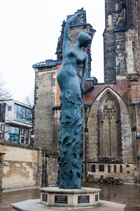 Low angle view of statue against buildings