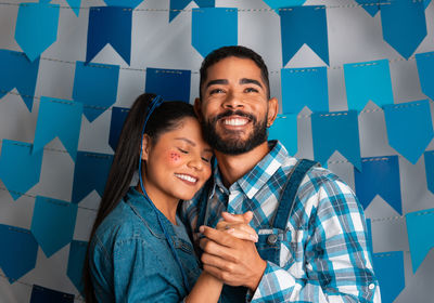 Portrait of smiling couple standing in office