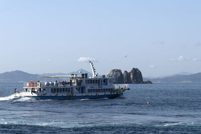 Ship sailing on sea against sky