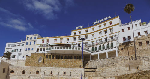 Low angle view of buildings against blue sky