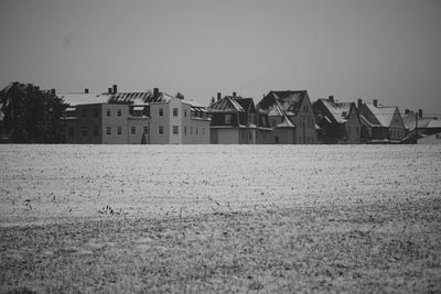 Houses on field against sky