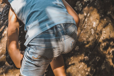 Rear view of boy standing on land