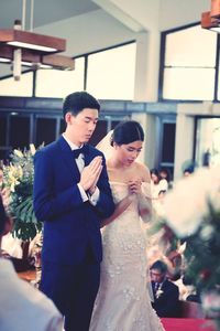 Young couple standing in church during wedding ceremony