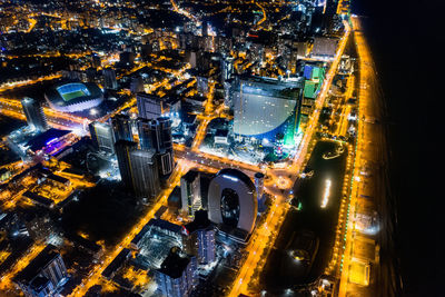 High angle view of city lit up at night