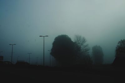 Silhouette of trees on landscape against sky