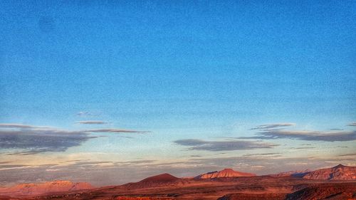 Scenic view of desert against blue sky