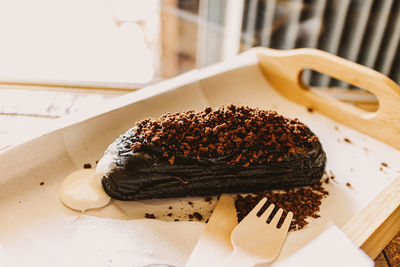 Dark chocolate bread with white creamy custard in a cafe.