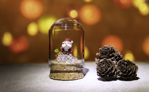 Close-up of figurine in jar on table